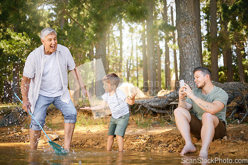 Image of Nature, lake and child with his grandfather and father playing, fishing and bonding on a vacation. Travel, happy and senior man having fun with adult son and grandchild in the woods on a weekend trip