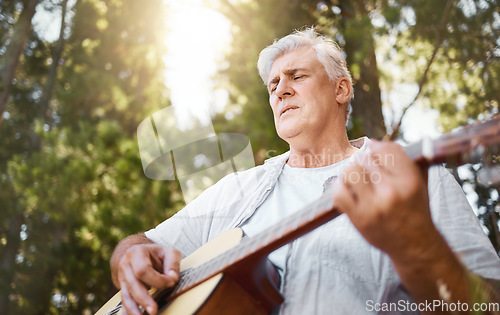 Image of Senior man, guitar and woods for camping, music and relax with freedom, peace and outdoor in summer. Elderly guy, instrument and performance in forrest, sunshine and retirement on vacation in nature