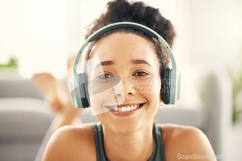 Image of Happy woman, face and headphones listening to music on floor in yoga for relaxation in living room at home. Portrait smile of female person or yogi with headset for audio streaming, sound or songs