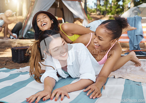 Image of Group, women friends and woods for camping, funny and laying on blanket with joke, diversity and vacation. Young girl students, comic laughing and playing on ground in summer, sunshine and forrest