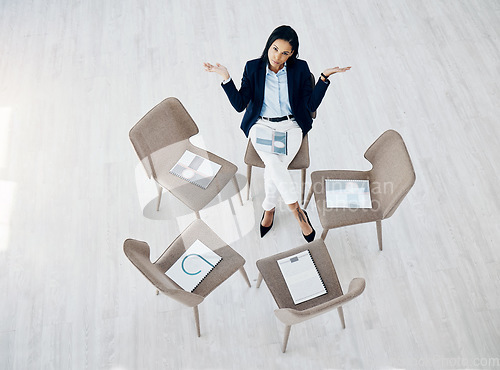 Image of Portrait, empty and waiting for a meeting with a business woman sitting on a chair in a corporate office from above. Why, question and late with an impatient female employee alone in the workplace