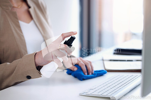 Image of Keyboard sanitize, woman hand and spray at a desk for bacteria safety in a office. Business person, company and computer cleaner with bottle for covid, virus and germ protection against infection