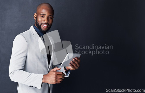 Image of Portrait, tablet and business man isolated on dark gray background and mockup for financial news or information. Face of corporate african person or accountant in suit on digital tech and banner wall