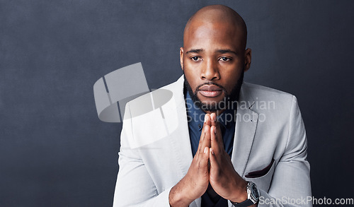 Image of Praying, hands and business man with faith for career, job or opportunity, asking god for help and support. Corporate african person in prayer sign, religion and hope isolated on dark wall background