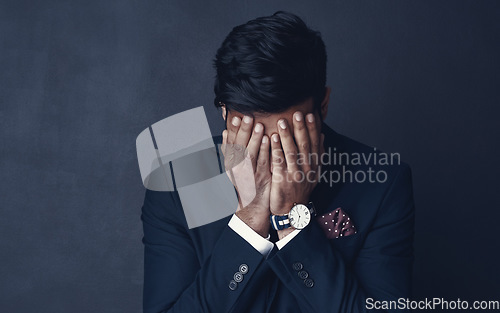 Image of Crying, sad and business man stress, frustrated or depressed for financial mistake, debt or crisis. Corporate person with depression for finance fail or stock market crash isolated on dark background