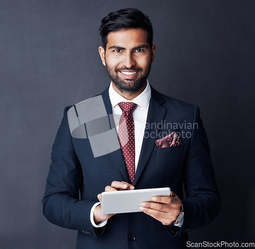 Image of Businessman, tablet and smile in studio, dark background or research stock market trading news online. Corporate trader, indian man or digital technology for investment management, finance or website