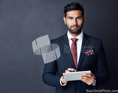 Image of Portrait, businessman or tablet in studio, mockup space or background for trading, planning or research. Corporate trader, serious indian man in suit or digital technology of online stocks investment