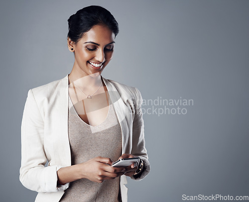 Image of Business, happy and woman with a smartphone, connection and online reading against a grey studio background. Female person, administrator or model with a cellphone, mobile application or website info