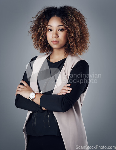 Image of Confident, portrait of a businesswoman against a studio background for serious mindset. Empowerment or assertive, elegance or proud and female person pose for success with arms crossed in backdrop