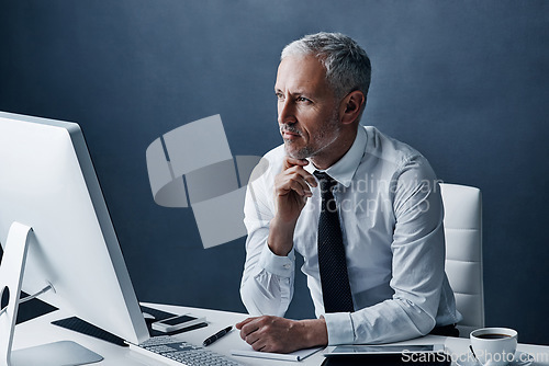 Image of Thinking, office and business man on computer for online project, internet and browse website at desk. Technology, corporate worker and mature male person on pc for research, email and planning