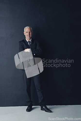 Image of Arms crossed, smile and portrait of business man in studio for professional, corporate or manager. Boss, pride and confidence with senior male ceo on black background for executive and mockup space