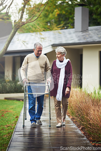 Image of Senior couple, garden and walker with chat, listen or together for love, bond or freedom in winter. Old woman, support and elderly person with disability in backyard, retirement or outdoor in morning