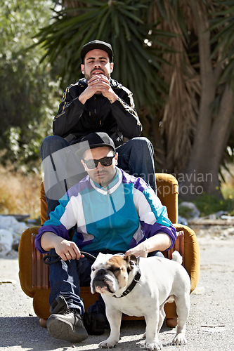 Image of Portrait, retro style and dog with friends and their pet outdoor in a downtown neighborhood together. Street, fashion and culture with men and their bulldog puppy on an urban background