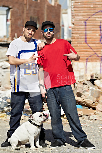 Image of Portrait, gang and dog with man friends and their pet outdoor in a dangerous neighborhood together. Street, crime and culture with male gangsters and their bulldog puppy on an urban background