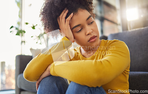 Image of African woman, sad and thinking on living room floor with worry, stress and memory of trauma in home. Gen z girl, anxiety and remember mistake, regret and mental health problem in lounge at apartment