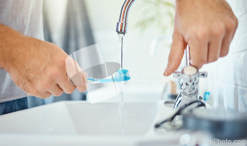 Image of Hands, toothbrush and person at tap for water, dental hygiene and gum care at home. Closeup, brushing teeth and rinse oral product for fresh grooming, morning routine and cleaning at bathroom sink