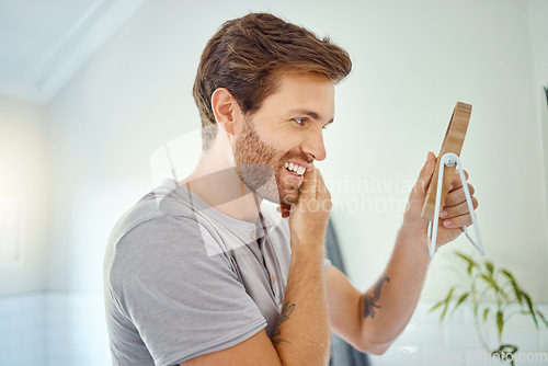 Image of Man in bathroom, checking face in mirror and smile with morning routine, health and wellness in home. Dental care, clean mouth and teeth with male grooming for fresh breath, hygiene and getting ready