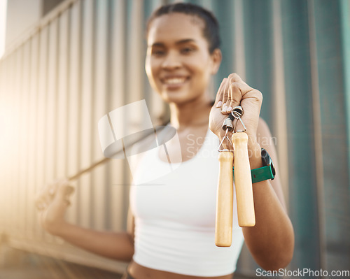 Image of Fitness, portrait and girl with rope in closeup in outdoor for jump for wellness with motivation. Female athlete, happy and ropes for cardio or exercise for workout or training in morning, smile.