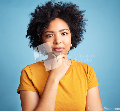 Image of Portrait, serious and woman with a decision, focus and girl against a blue studio background. Face, female person or model with problem solving, solution or fantasy with future, assertive or question