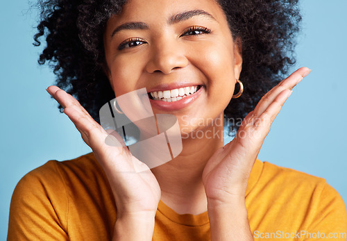 Image of Happy, portrait of a woman with smile and against a blue background for health wellness. Happiness or satisfaction, cheerful and face of female person pose for positivity against studio backdrop