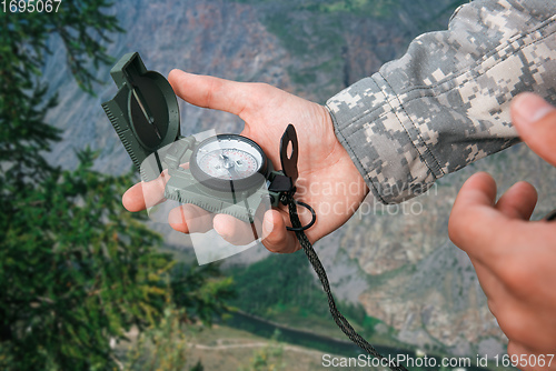 Image of Man with compass in Altai mountains