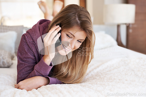 Image of Phone call, bed and woman speaking and relax in a bedroom for a conversation or communication using a mobile app. Social network, home and happy female person talking online using cellphone internet