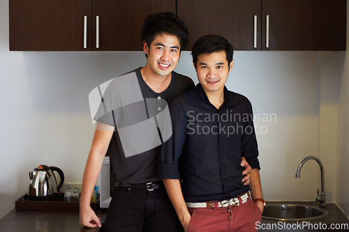 Image of Happy, Asian and portrait of a gay couple with a hug, care and bonding in a home kitchen. Smile, lgbtq love and men together in a house to relax with an embrace and affectionate in relationship