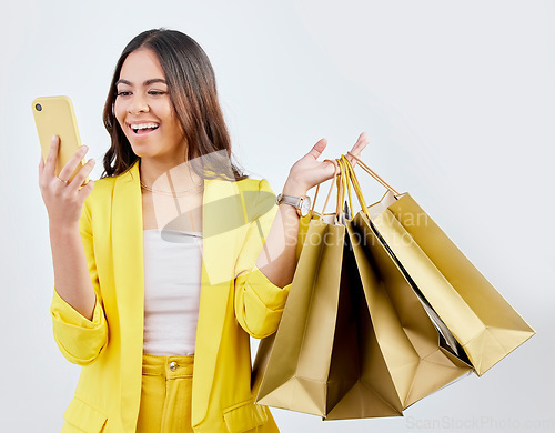 Image of Fashion, phone or happy woman on social media with shopping bags for a sale, offer or discount code. Online, mobile app or excited girl customer with gift or present on promotion on white background