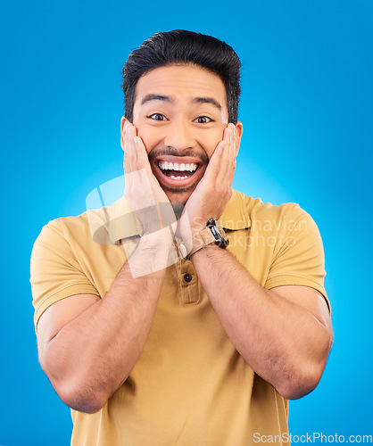Image of Happy, excited man and surprise portrait in studio with Asian model with teeth and joy. Blue background, male person and casual fashion with handsome and friendly guy with modern style and wow face