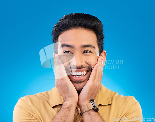 Image of Happy, excited man and surprise face in studio with Asian model with teeth and joy. Blue background, male person and casual fashion with handsome and friendly guy with modern style and wow smile