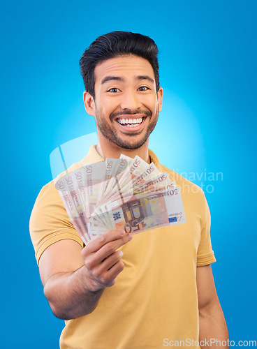 Image of Money fan, portrait and man or winner with bonus offer, financial success and winning, finance loan or lottery. Asian person with savings, winning cash and profit isolated on studio, blue background