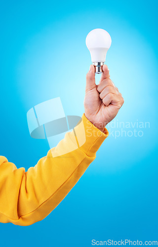 Image of Thinking, lightbulb ideas and hands of person with solution, problem solving plan or strategy development. Innovation, light bulb and studio model with entrepreneurship inspiration on blue background