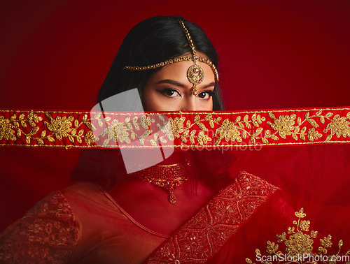 Image of Fashion, eyes and portrait of Indian woman with veil in traditional clothes, jewellery and sari. Religion, beauty and female person on red background with accessory, cosmetics and makeup for culture