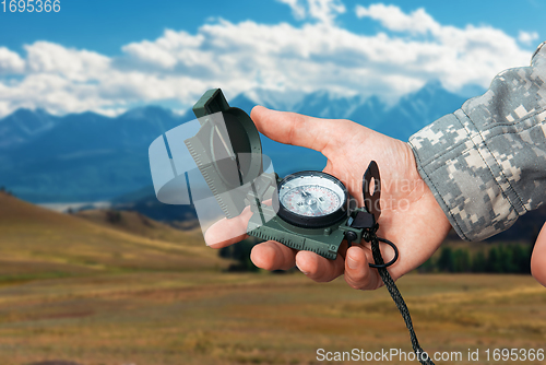 Image of Man with compass in Altai mountains