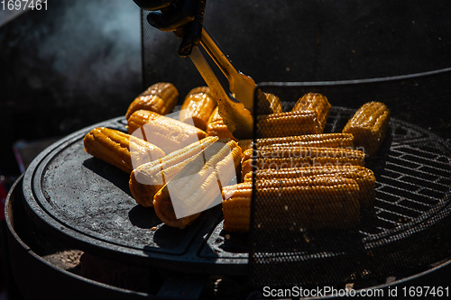 Image of A professional cook prepares corn