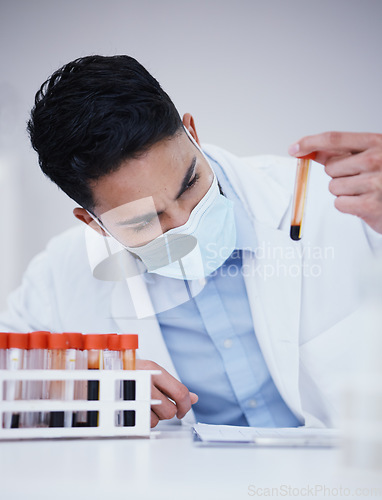 Image of Blood test, tube and scientist man with research analysis, vaccine and healthcare face mask in laboratory. Medical, science doctor or person focus, inspection and red, dna liquid or covid 19 solution