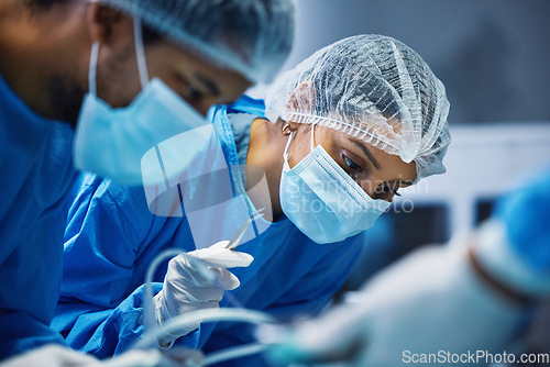 Image of Hospital knife, surgery and doctors in theatre for medical support, teamwork and emergency healthcare with focus. Doctor, nurse and surgeon face mask, patient check and tools in operating room