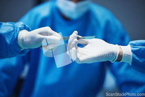 Image of Hospital knife, surgery and doctors hands in theatre for medical support, teamwork and emergency healthcare. Doctor, nurse and surgeon team work, giving tools and helping in operating room zoom