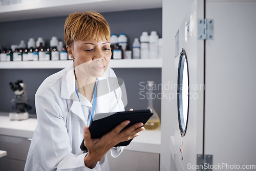Image of Scientist, tablet and serious woman with incubator in laboratory, research or online study. Technology, medical professional and doctor of science on internet for reading, healthcare and email app.