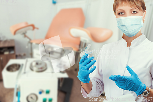 Image of Female gynecologist in protective mask