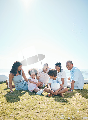 Image of Parent, children and generations are relaxing on grass in summer for quality time on holiday in mockup space. Happiness, kid and big family in outdoor for bond at resort with ball at house or ocean.