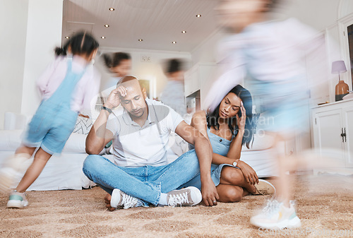 Image of Running, home and parents with stress, kids and tired with burnout, anxiety and noise in a living room. Mother, father and energetic children in a lounge, adhd and fatigue with motion and headache