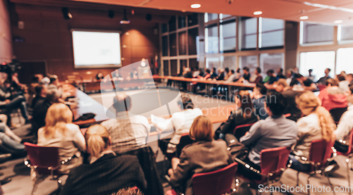 Image of Public speaker giving talk at business event.