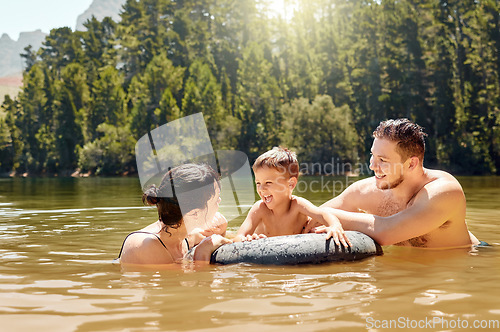 Image of Parents, son and float on lake with inflatable, smile and excited for camping, vacation or swimming together. Man, woman and male child with happy family, holiday and tube on river in summer in woods