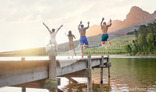 Image of Lake, jump and group of friends for holiday, summer camping and freedom, celebration or success from behind. carefree, cheers and excited people in air for swimming, water and mountains on vacation