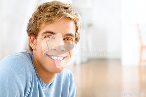 Image of Portrait, home and man with a smile, cheerful and confident guy is his living room, casual outfit and Canadian. Face, happy male person and gentleman in his lounge, happiness and joyful with wellness