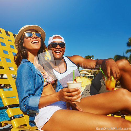 Image of Couple, poolside and drinks in summer with happiness on holiday with alcohol at resort. Vacation, cocktails and pool with man or woman with alcohol in outdoor with sunshine, happy, sunglasses.