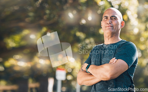 Image of Man, outdoor and arms crossed portrait in a park for fitness, workout and athlete training. Male person, mature and wellness in nature with mockup and confidence in a forest for sport and health