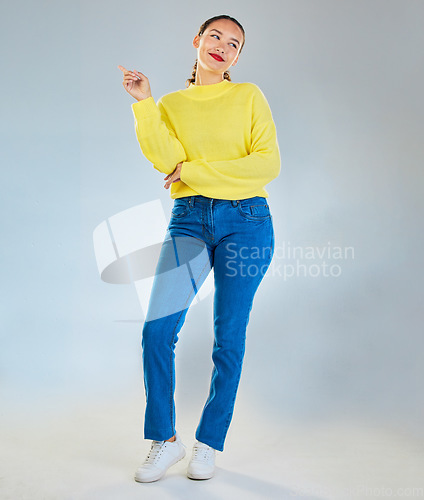 Image of Thinking, pointing and presentation with portrait of woman in studio for show, advertising and idea. Announcement, promotion and deal with person on grey background for space, news and mockup