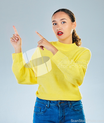 Image of Pointing, shock and presentation with portrait of woman in studio for show, advertising and idea. Announcement, wow and deal with person on grey background for opportunity, offer and news mockup